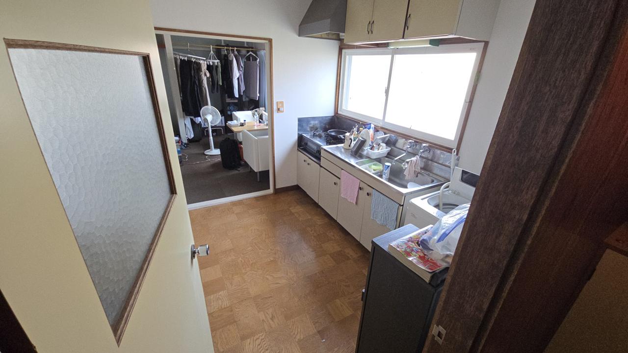 The kitchen. Note the hose where we plug our washing machine into the sink to do laundry!