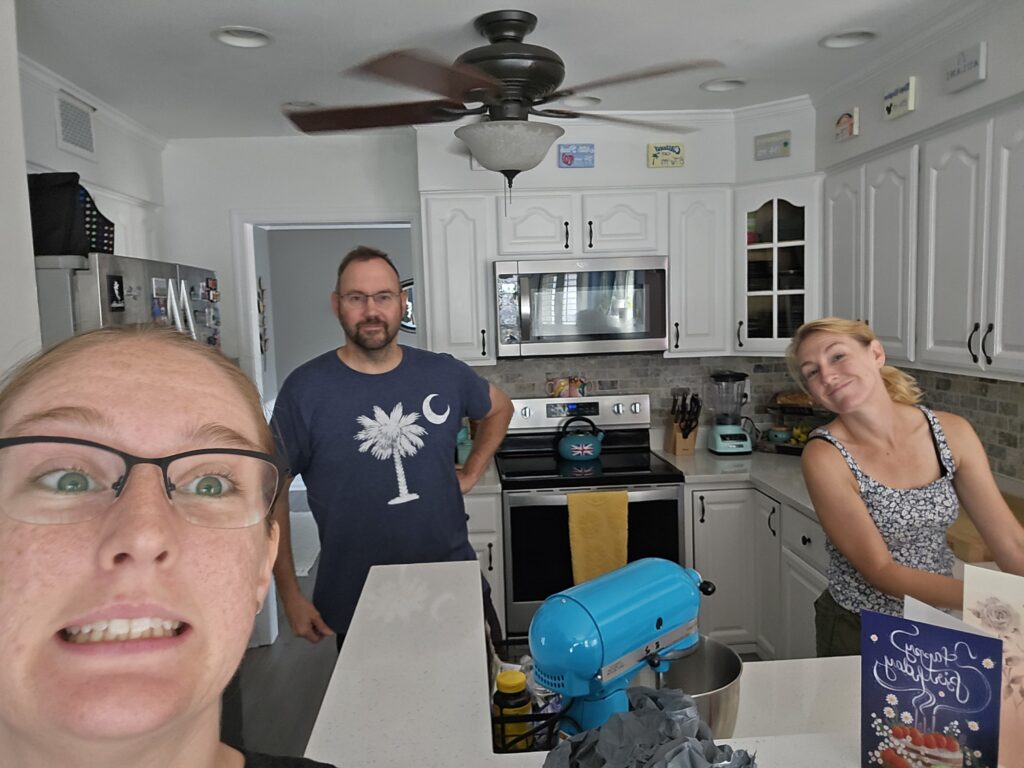 Cassie making a face in the kitchen with Candace and Tim